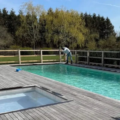 Henry Bona Pools & Spas - Man Cleaning Pool